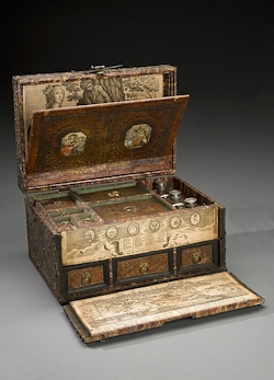 Medicine chest, wooden, iron-bound and brass covered, lock broken, decorated with studs and embossed design outside, and tooled leather and prints inside, containing 3 pewter topped glass bottles and one other bottle 1751-1800.